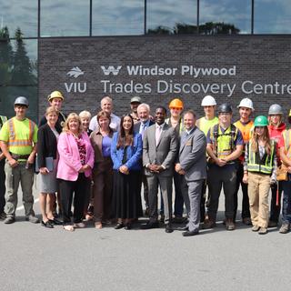 A group of students staff and politicians standing in front of the VIU Trades Discovery centre