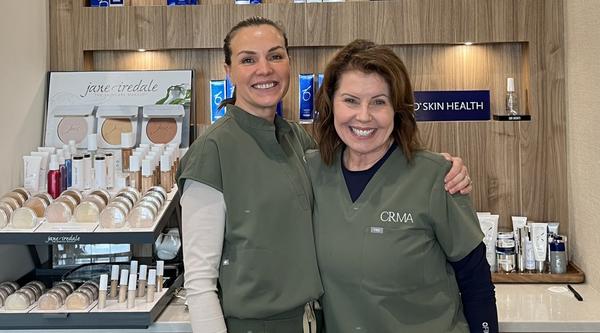 Gillian Stuart with a colleague smiling at the camera.