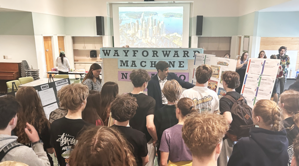 Michael MacKenzie showing a group of students some of the work done for the Futures Fair.