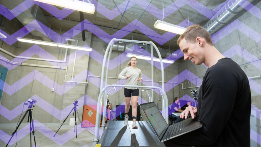 a student with a laptop observes another student running on a treadmill
