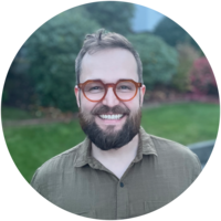 Smiling man wearing glasses. 