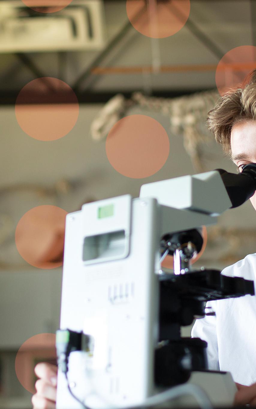 Young man at microscope.